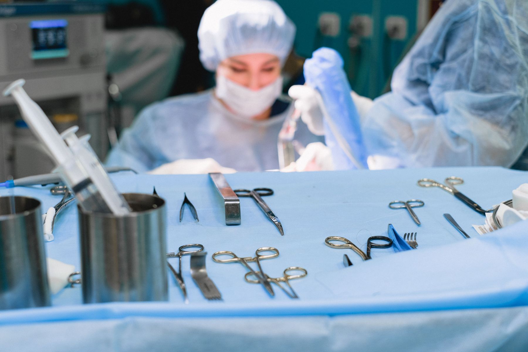 A nurse at work beside a prepared instrument tray